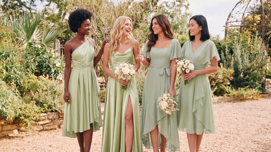 Four bridesmaids wearing mix-and-match sage green INEWER dresses in a garden